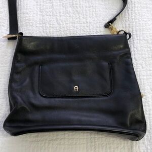Etienne Aigner black leather shoulder bag with gold hardware.